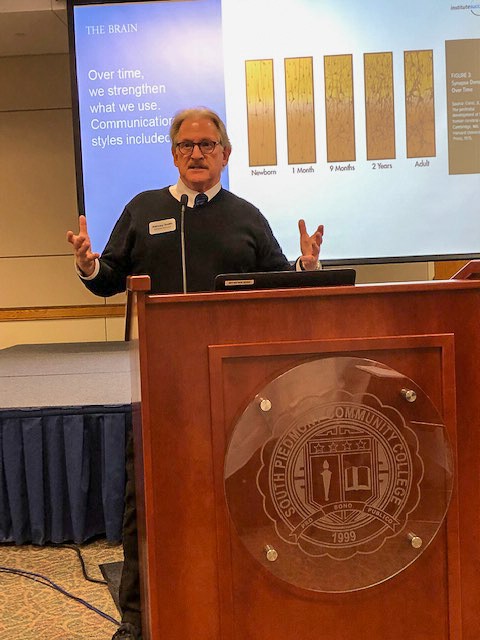 Harvey Smith standing at a podium during a training class